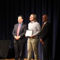 Man standing with award